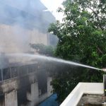 Massive fire and thick black smoke billowing from a fan factory in Mudhaila, Varanasi, causing panic in the adjacent Meghna hospital