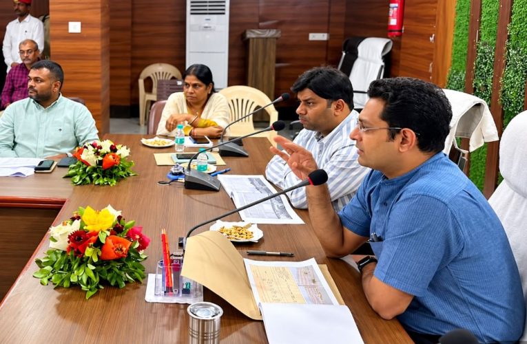 Indian DM chairing meeting, UP bureaucrat review meeting, Jaunpur collectorate auditorium, Indian government officials meeting, construction project review India