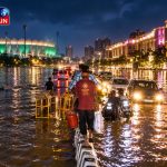 Lucknow flood rescue operation boat, village houses submerged in flood water India, urban waterlogging street, Indian villagers moving with cattle flood, Gomti river overflowing